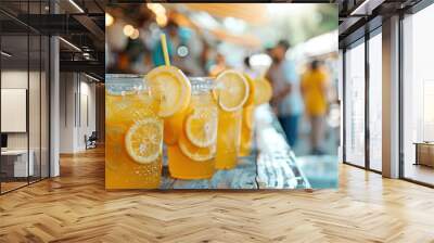 Rows of fresh lemonade in plastic cups with lemon slices at a vibrant market, capturing a refreshing summer vibe. Wall mural