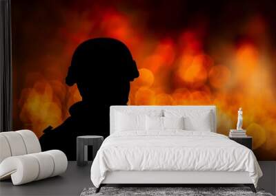 Silhouette of a military person with a blurred background of warm bokeh lights, depicting vigilance and remembrance. Wall mural