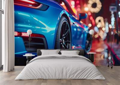 Sleek blue sports car parked on a neon-illuminated wet city street at night, reflecting lights. Wall mural