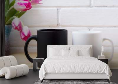 Black coffee mug and white cappuccino cup mockup with pink tulips Wall mural