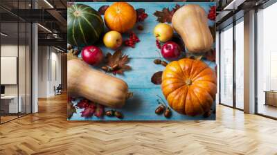 Thanksgiving  concept with pumpkins and leaves on blue wooden ba Wall mural