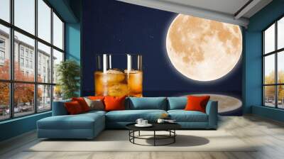 Whiskey glass on midnight sky with full moon background. Wall mural