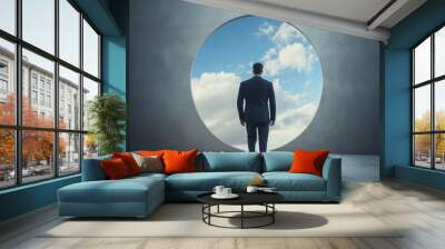 A person walks toward a circular portal leading to the sky, symbolizing pathways, choices, and new beginnings Wall mural