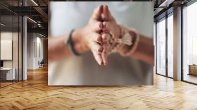 Balancing my chakras. Cropped shot of an unrecognizable woman standing with her palms together while meditating indoors. Wall mural