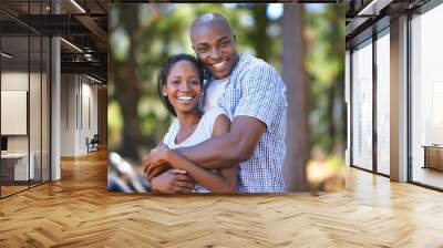 Hug, portrait or black couple hiking in forest to relax or bond on holiday vacation together in nature. Happy, travel or African woman with smile or man in woods trekking on outdoor park adventure Wall mural