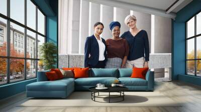 Surround yourself with strong women. Portrait of a group of businesswomen standing together against a city background. Wall mural