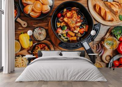 Variety of dishes cooked in the air fryer on the kitchen table Wall mural