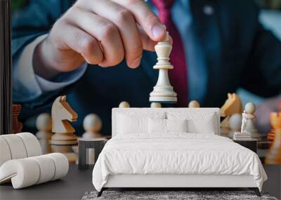 Businessman making a strategic move in chess game, holding a white queen. Concept of leadership, strategy, and decision-making in business. Wall mural