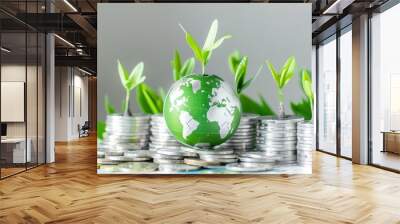 Stacks of coins with green sprouts and a small globe. Sustainable finance and environmental investment concept. Wall mural