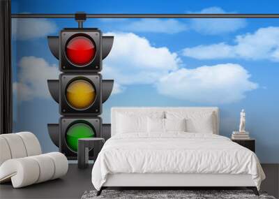 Traffic lights with all three colors on hanging against blue sky Wall mural