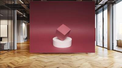 Bright balance of 2 pedestals (cube and round) on a paper background. In dark pink, with gradient. Advertising place. Blank product stand and abstract background with light. Wall mural