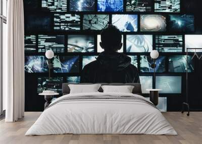 A man stands in front of a wall of computer monitors Wall mural