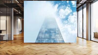 A tall building with a cloudy sky in the background Wall mural