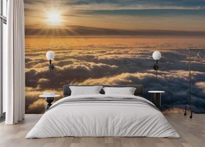 Aerial view of sunset clouds with sun rays shining through fog, capturing a detailed and picturesque cloudscape. Wall mural