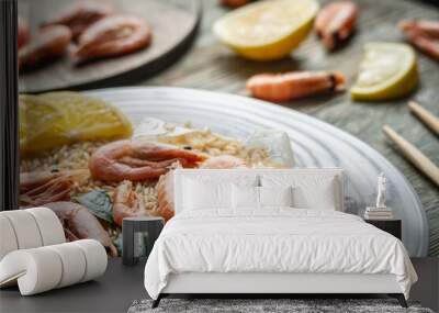 Appetizing delicious frozen dish of shrimps and rice with lemon on a wooden table. Concept of ready made frozen food for dinner like in a restaurant at home. Closeup Wall mural