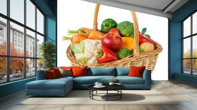 Fresh fruits and vegetables in a wicker basket. Isolated. Wall mural