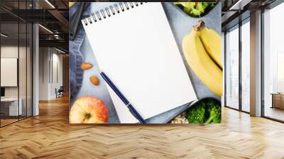 Healthy diet lunch boxes with food and empty notepad. Wall mural