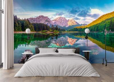 Calm morning view of Fusine lake. Colorful summer sunrise in Julian Alps with Mangart peak on background, Province of Udine, Italy, Europe. Beauty of nature concept background Wall mural