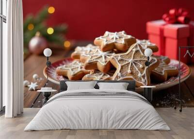 Christmas glazed gingerbread cookies layout on a plate over festive decoration with gifts, stars, spruce branches and serpentine. Wall mural