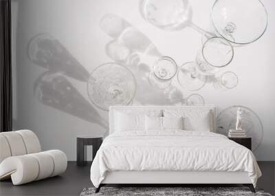 Different empty glasses on white background. Direct sunlight. Top view, flat lay, copy space. Wall mural