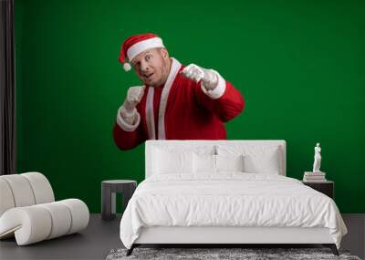 Emotional Santa Claus box and fights on a green chrome background Wall mural