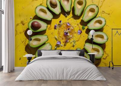 Exotic halved avocados against a bright yellow background. Wall mural