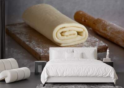 Rolled raw homemade puff pastry on kitchen board  Wall mural