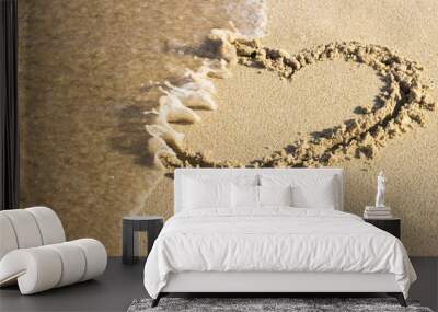 heart drawn on sand is washed off by sea wave, top view End relationship. Wall mural