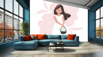 Nice cartoon girl in a white dress with a basket of flowers. Tender vector illustration. Pretty young woman with a long brown hairs. Wall mural