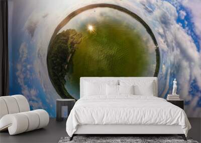 Panoramic view from drone, green little planet and blue sky around the globe Wall mural