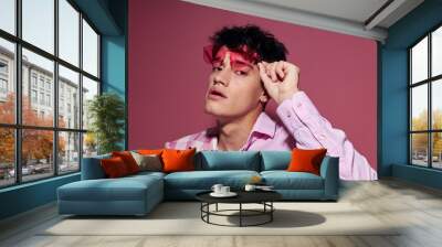 portrait of a young man pink shirt and glasses jacket fashion elegant style isolated background unaltered Wall mural