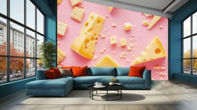 Cheese blocks and crunchy snacks on pink background, creative flat lay with crumbled cheese and crispy snacks scattered around Wall mural