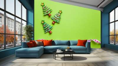 top view Christmas trees on green background. Free copy space. Concept of decoration, greeting cards Wall mural