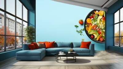 Top view on vegan salad from green leaves mix and vegetables on blue background generated AI Wall mural