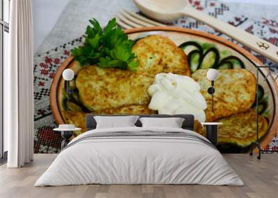 Traditional Slavic cuisine potato pancakes. Potato pancakes. Food served on a clay plate with sour cream. In ancient times, a wooden spoon and a wooden fork were sold. The towel is decorated with a na Wall mural