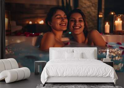 Two women are in a bathtub with candles lit around them Wall mural