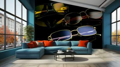 Various sunglasses and polarization glasses on a black background. Wall mural