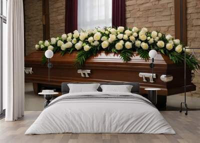 A brown coffin and a wreath of white roses at the funeral agency Wall mural