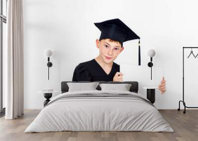 A boy in a student hat holding an empty Billboard . Knowledge, education and successful career.Isolated on white background.Portrait of a confident smart boy. Wall mural