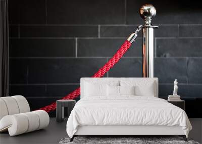 Single silver stanless stanchion with red velvet rope. Crowd control concept. Barrier rope isolated on black background. Luxury, VIP. Red block. Wall mural