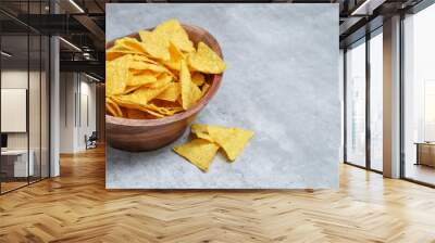 Salted tortilla in a wooden bowl, grey marble table with copy space Wall mural