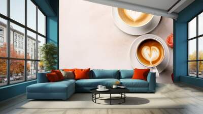 Top view of two cappuccino cups with heart shaped milk foam, white table with decoration  Wall mural