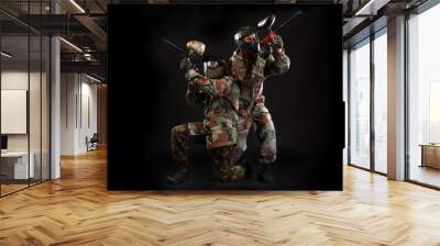 Studio shot of two paintball players on black background Wall mural