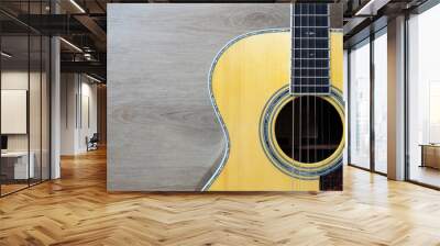 close up acoustic guitar on wooden table background, music concept Wall mural