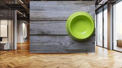 Empty dog food bowl on wood table background Wall mural