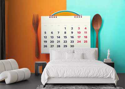 Food diary or food daily calendar, dish spoon and fork on the color table background, health concept Wall mural