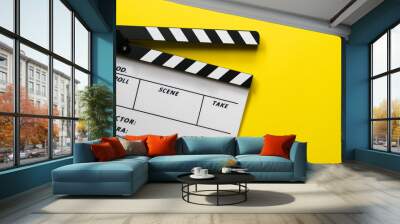 movie clapper on yellow table background ; film, cinema and video photography concept Wall mural