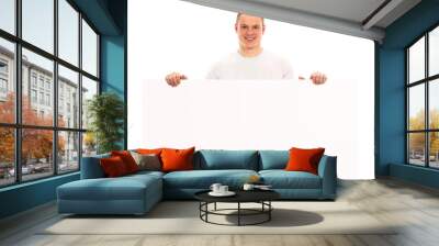 Closeup of a happy male standing by white blank card Wall mural