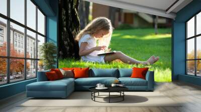 Child with tablet pc outdoors Wall mural