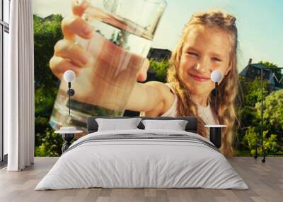 Girl holding glass with water Wall mural